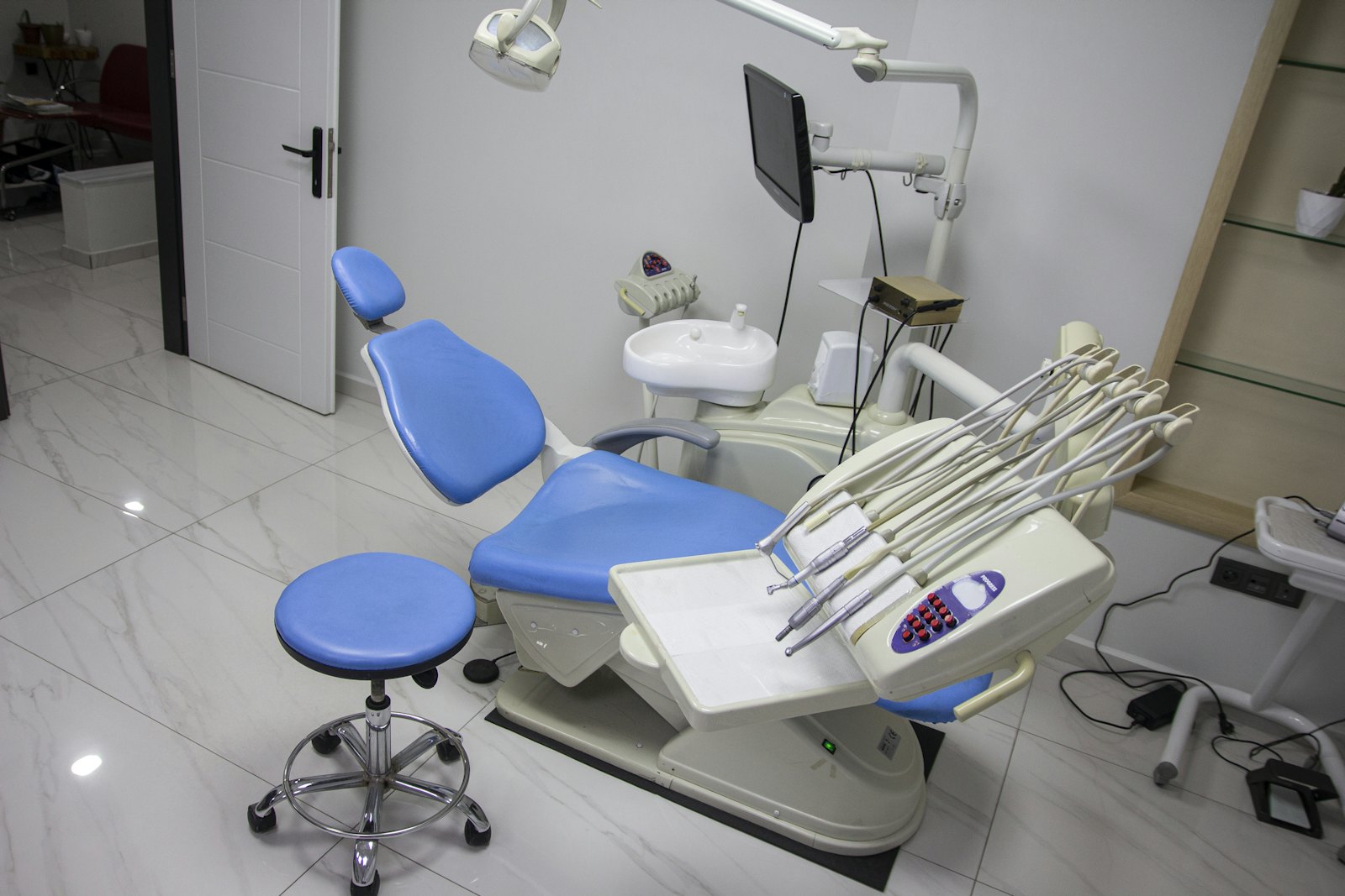 Dental surgery with a blue patient chair and equipment